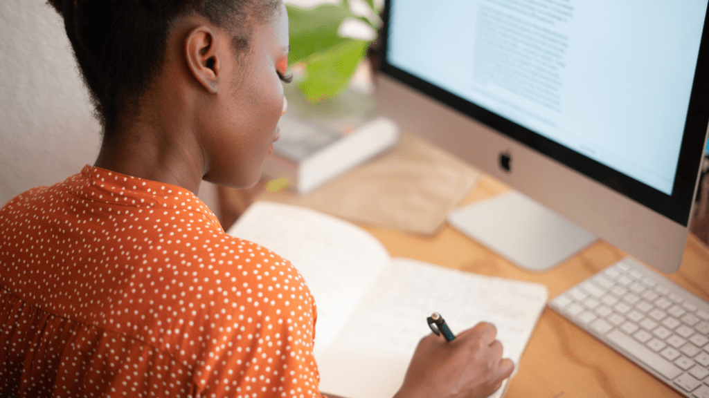 woman writing on her notes