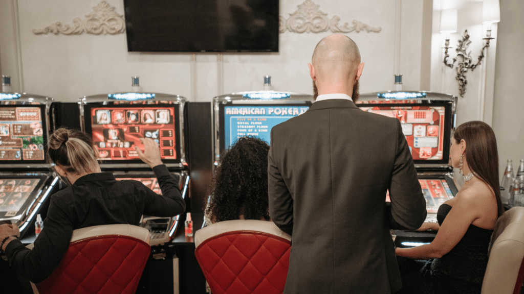 a group of people playing slot machines