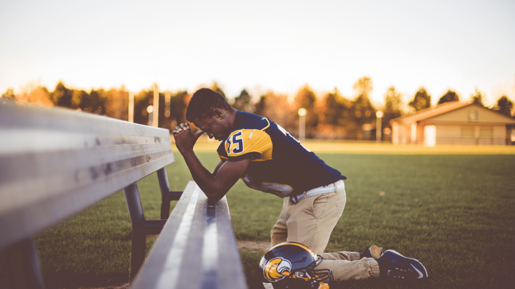 an athlete praying