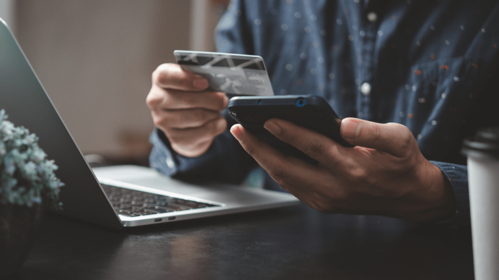 man holding a card an cellphone